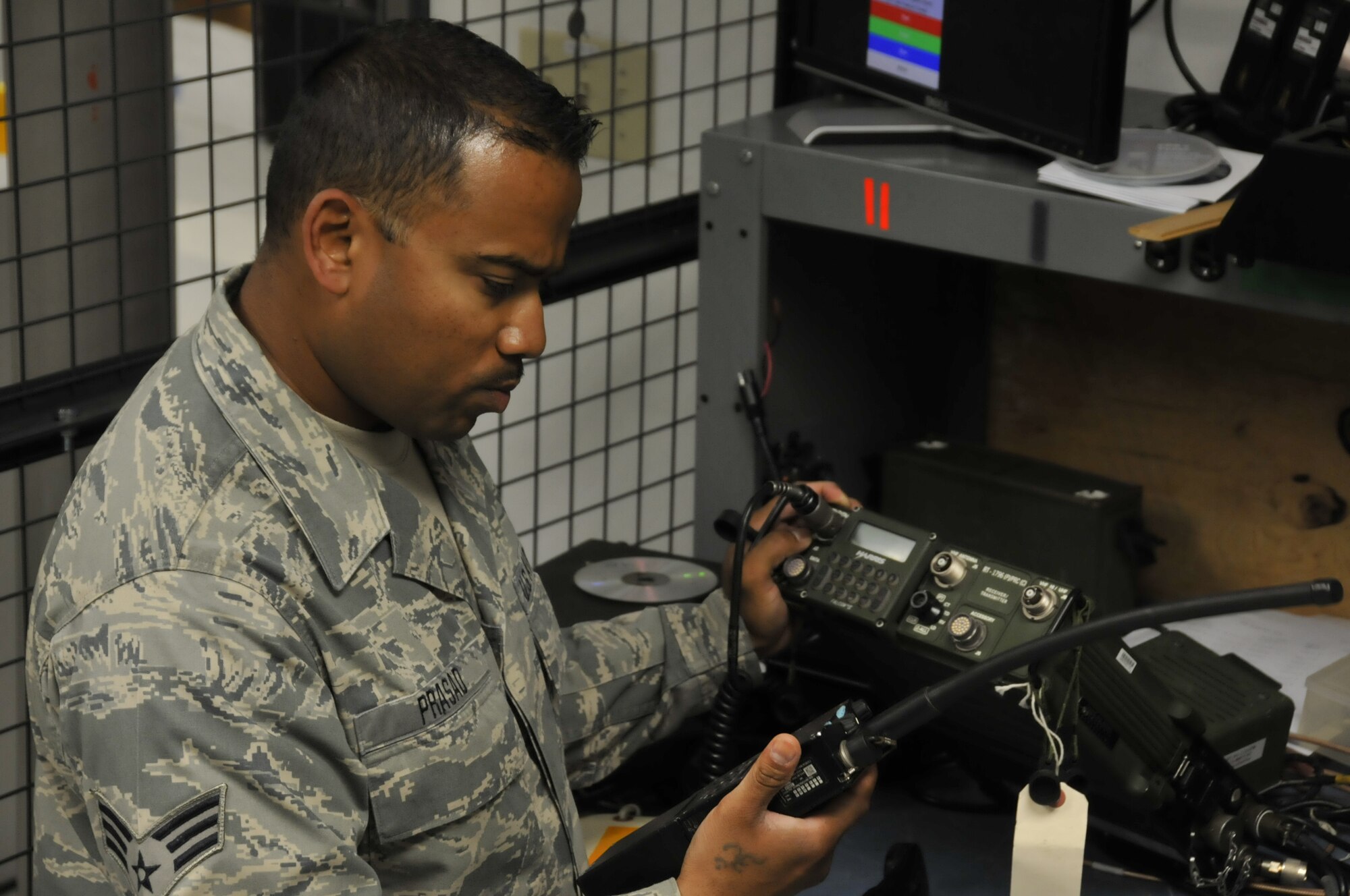 Senior Airman Deepak Prasad, a ground radio technician assigned to the 129th Communications Flight, conducts operational check on a ground radio TRC-176 communication system at Moffett Federal Airfield, Calif., July 10, 2011. Prasad is featured in this month's Portrait of a Professional. (California Air National Guard photo by Airman 1st Class John Pharr)