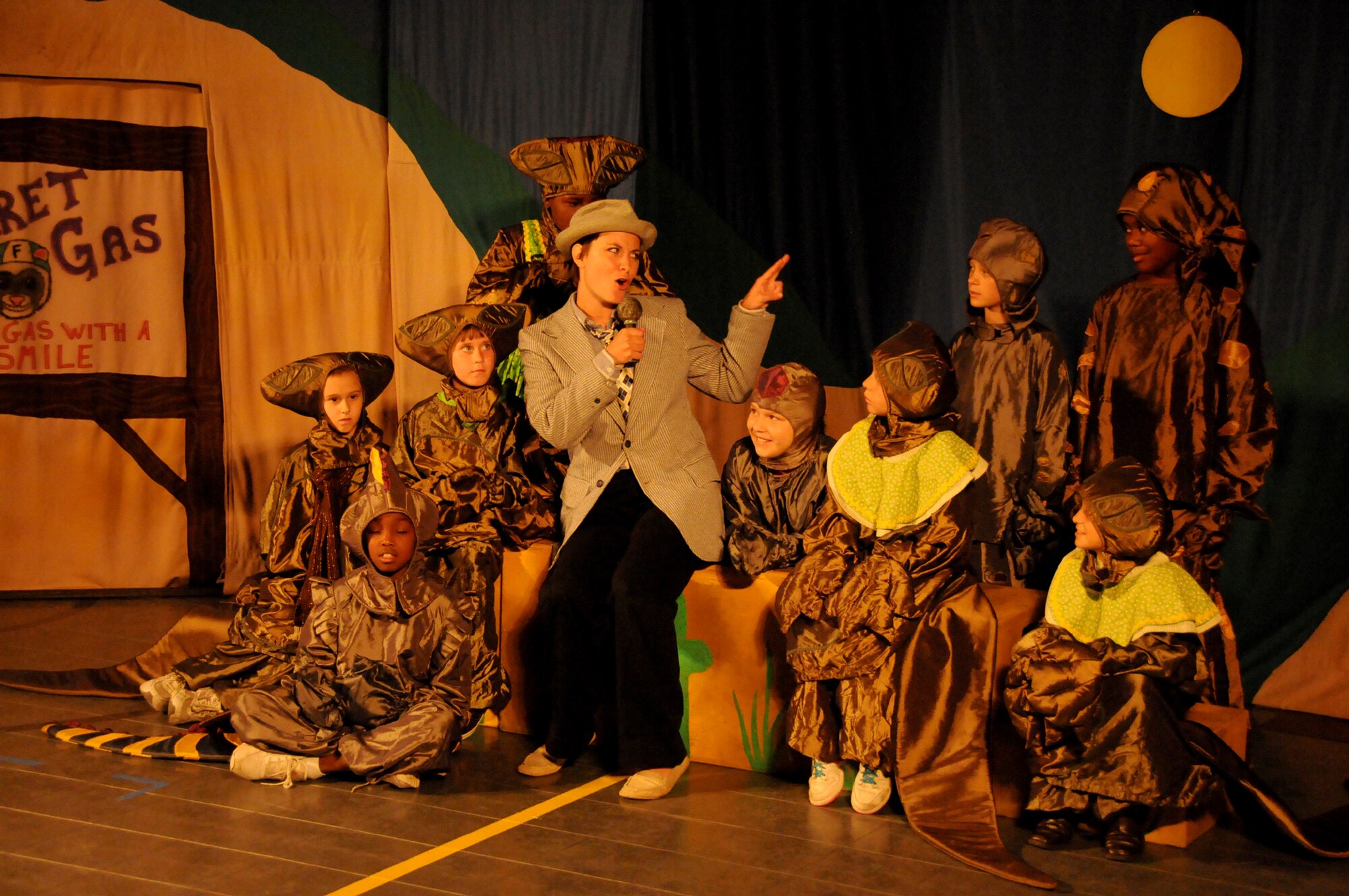 Tour director and actor Lanella Zotter, center, from the Missoula Children’s Theater
tour team, rehearses with young Keesler actors for the presentation of “The Tortoise versus The Hare,” July 28. Zotter and Lucy Habdas worked with the children during a
week-long drama camp at the youth center. Ninety-five children auditioned for the 59
youth roles in the production.  (U.S. Air Force photo by Kemberly Groue)