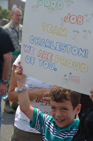 James Clavenna holds up a sign congratulating  Team Charleston, July 30, 2011, at Joint Base Charleston-Air Base, S.C., on their outstanding performance in Air Mobility Rodeo 2011. James is the son of Col. Tony Clavenna, 437th Maintenance Group commander. (U.S. Air Force photo/2nd Lt. Susan Carlson) 