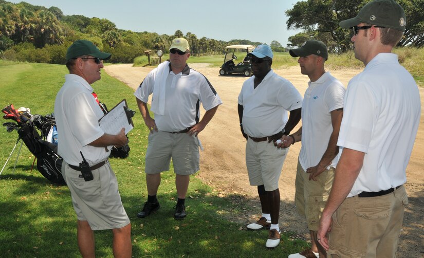 (Left to right) Petty officer 1st class Jerry Winebarger , Army Sgt. Kevin Bessellieu, Air Force Staff Sgt. Nicholas Sansone and Senior Airman Brad Nicholson listen to the rules before playing 18-holes of golf, Aug. 2, 2011, at Kiawah Island, S.C., during a Professional Golfers Association of America military appreciation event.  The event was held to announce that active duty military will be able to attend the 2012 PGA Championship free of charge. Winebarger is from Joint Base Charleston-Weapons Station Galley, Bessellieu is from the 841st Transportation Battalion, Sansone is from the 437th Aerial Port Squadron and Nicholson is from the 628th Contracting Squadron. (U.S. Air Force photo/Airman 1st Class Jared Trimarchi) 