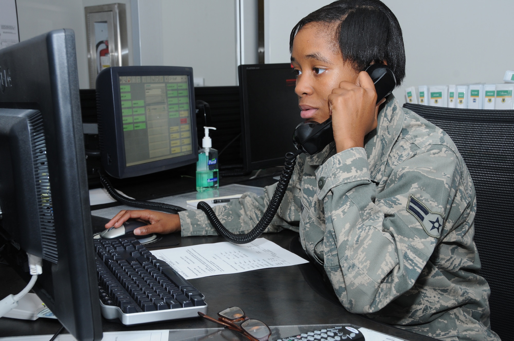 Airman 1st Class Ronnequa Pinkney, 81st Trainint Wing command controller, at work inside the command post, communicates with the 403rd Maintenance Squadron for an update on the status of their aircraft.  (U.S. Air Force photo by Kemberly Groue)