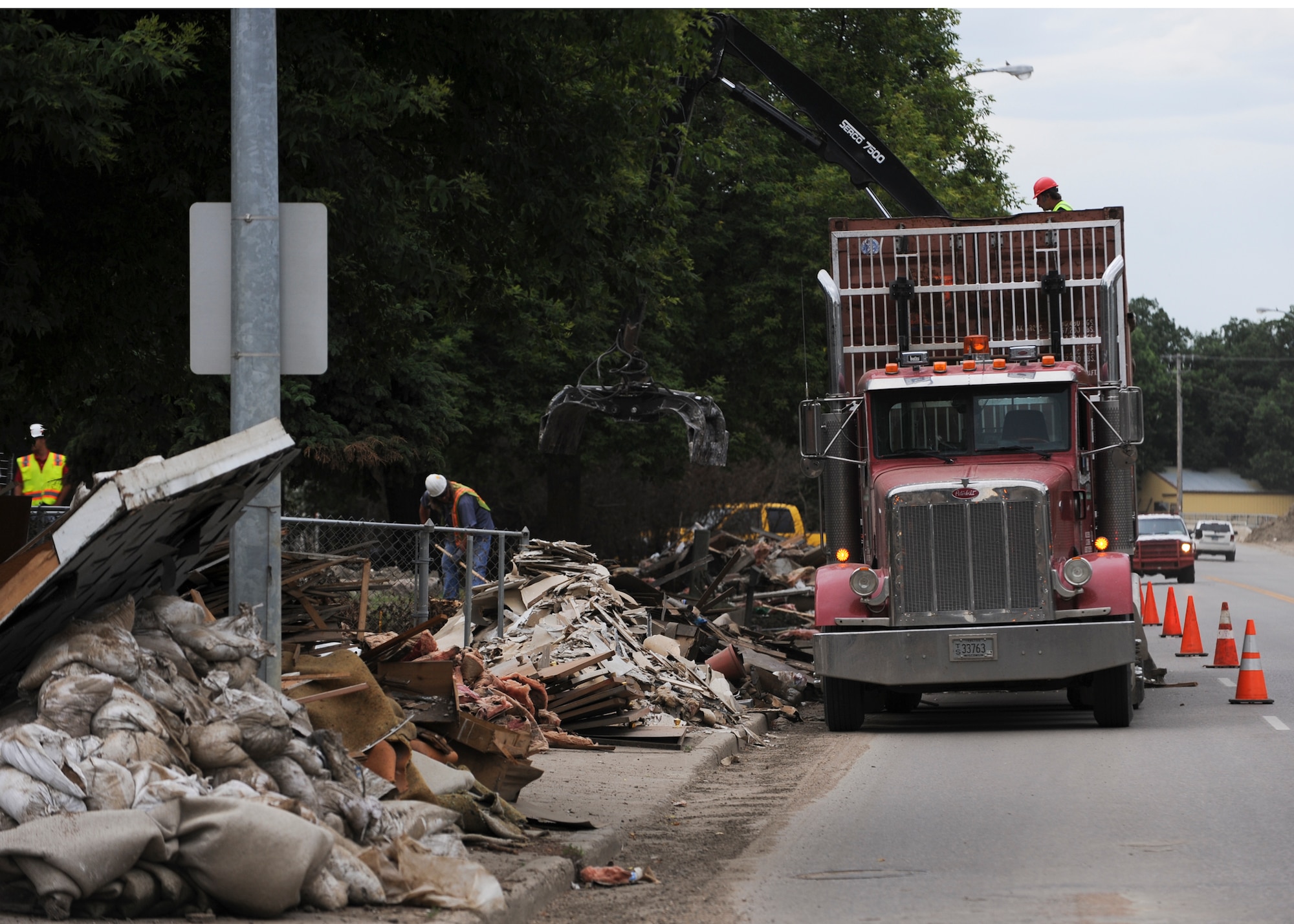 MINOT, N.D. -- City workers begin picking up damaged goods along the flood-damaged streets of downtown Minot here Aug. 3. Due to the severe 2011 Minot flood, many residents have been forced out of their homes. (U.S. Air Force photo/Senior Airman Ashley N. Avecilla)