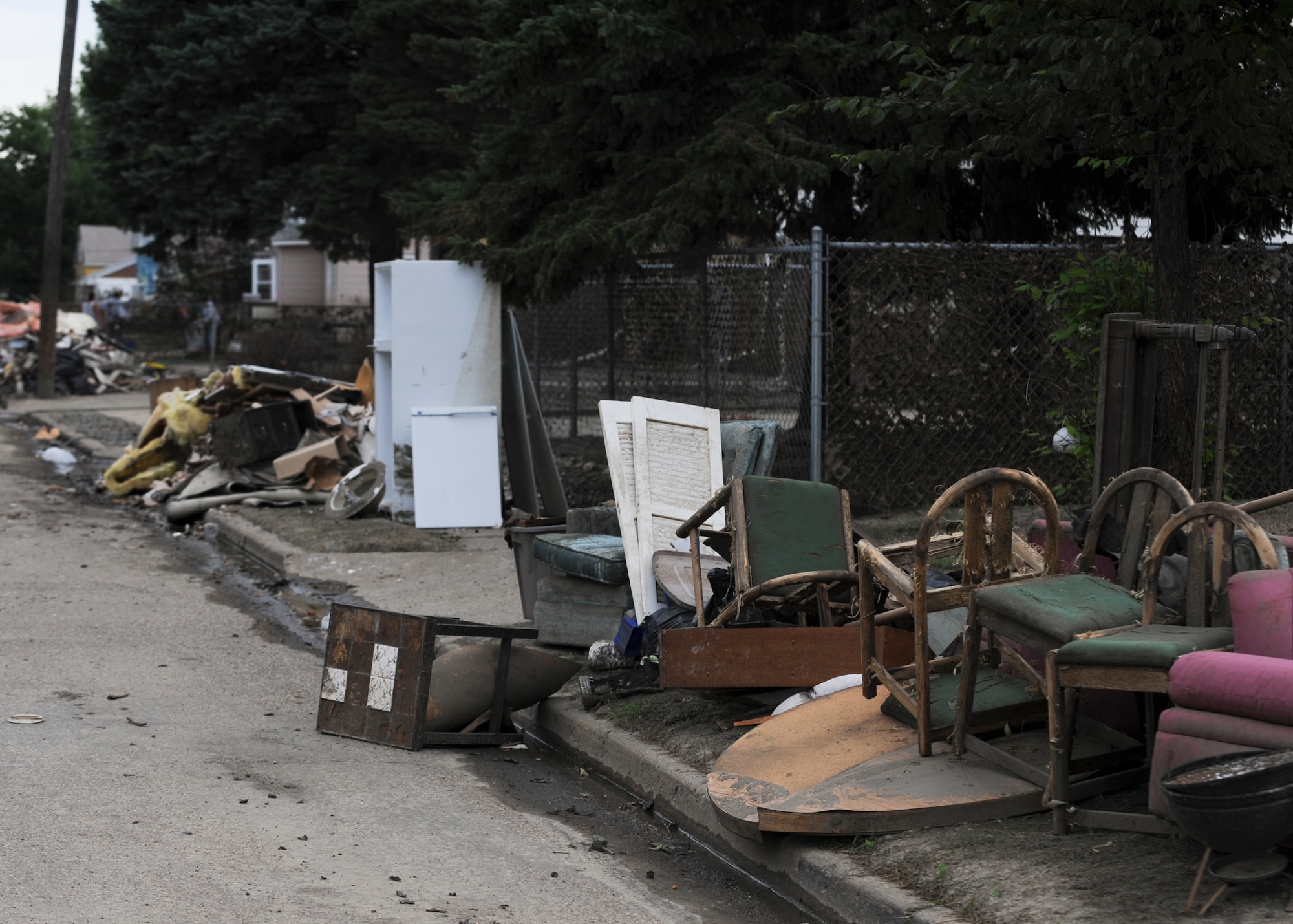 MINOT, N.D. -- As a result of the recent flooding, Minot residents have had to empty their homes of damaged items which now fill the streets of downtown Minot here, Aug. 3. Due to the severe 2011 Minot flood, many residents were forced out of their homes. (U.S. Air Force photo/Senior Airman Ashley N. Avecilla)