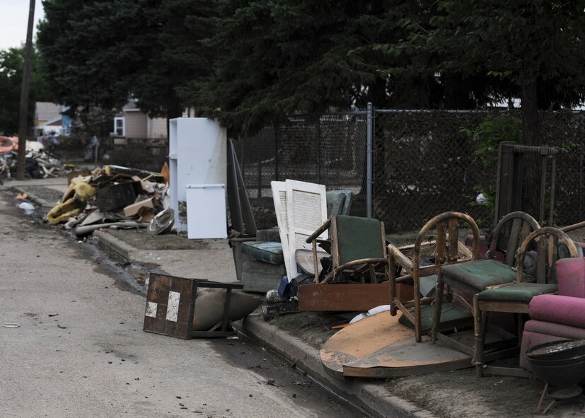 MINOT, N.D. -- As a result of the recent flooding, Minot residents have had to empty their homes of damaged items which now fill the streets of downtown Minot here, Aug. 3. Due to the severe 2011 Minot flood, many residents were forced out of their homes. (U.S. Air Force photo/Senior Airman Ashley N. Avecilla)