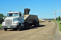 MINOT AIR FORCE BASE – Contractors repair pot holes and reconstruct the road along Missile Avenue to the front gate, resulting in detours through base housing, here Aug. 02. This project will improve the roads on base as well as add a turning lane to relieve the traffic surrounding the shoppette. (U.S. Air Force Photo/ Senior Airman Jesse Lopez)
