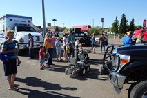 MINOT, N.D. -- Families witness an explosive ordinance disposal robot demonstration during National Night Out here Aug. 2. National Night Out recognizes emergency service members for their selfless work protecting our communities. (U.S. Air Force photo/Senior Airman Michael J. Veloz)