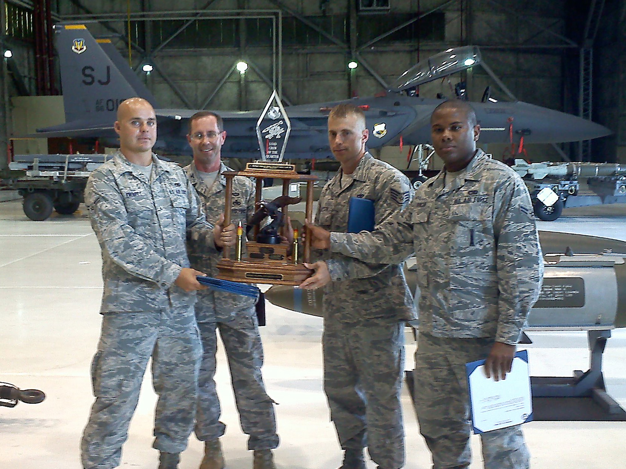 SEYMOUR JOHNSON AIR FORCE BASE, N.C. – Airman 1st Class Jacob Edward, Col. Thomas Eisenhauer, 4th Maintenance Group commander, Staff Sgt. Darren Kressin and Airman 1st Class Anthony Duncan from the 334th AMU Aircraft Maintenance Unit pose with a traveling trophy for winning the quarterly load crew competition here July 29, 2011. (Courtesy photo)