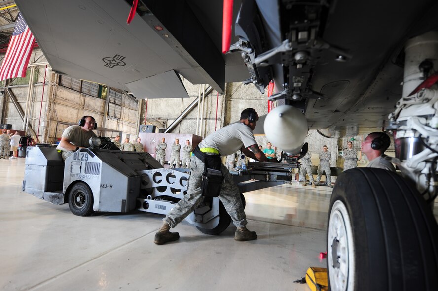 SEYMOUR JOHNSON AIR FORCE BASE, N.C. – Staff Sgt. Victor Williams and Senior Airman Curtis Benson direct Senior Airman Charles Cordell where to position the AIM-120 during a weapons load crew competition here July 29, 2011. The three-man crew placed third out of the four squadrons. Williams, 336th Aircraft Maintenance Unit weapons load crew one-man, is a native of Fayetteville, Benson, 336th AMU weapons load crew three-man, hails from Newton, and Cordell, 336th AMU weapons load crew two-man, is from Anderson, S.C. (U.S. Air Force photo by Senior Airman Rae Perry/RELEASED)