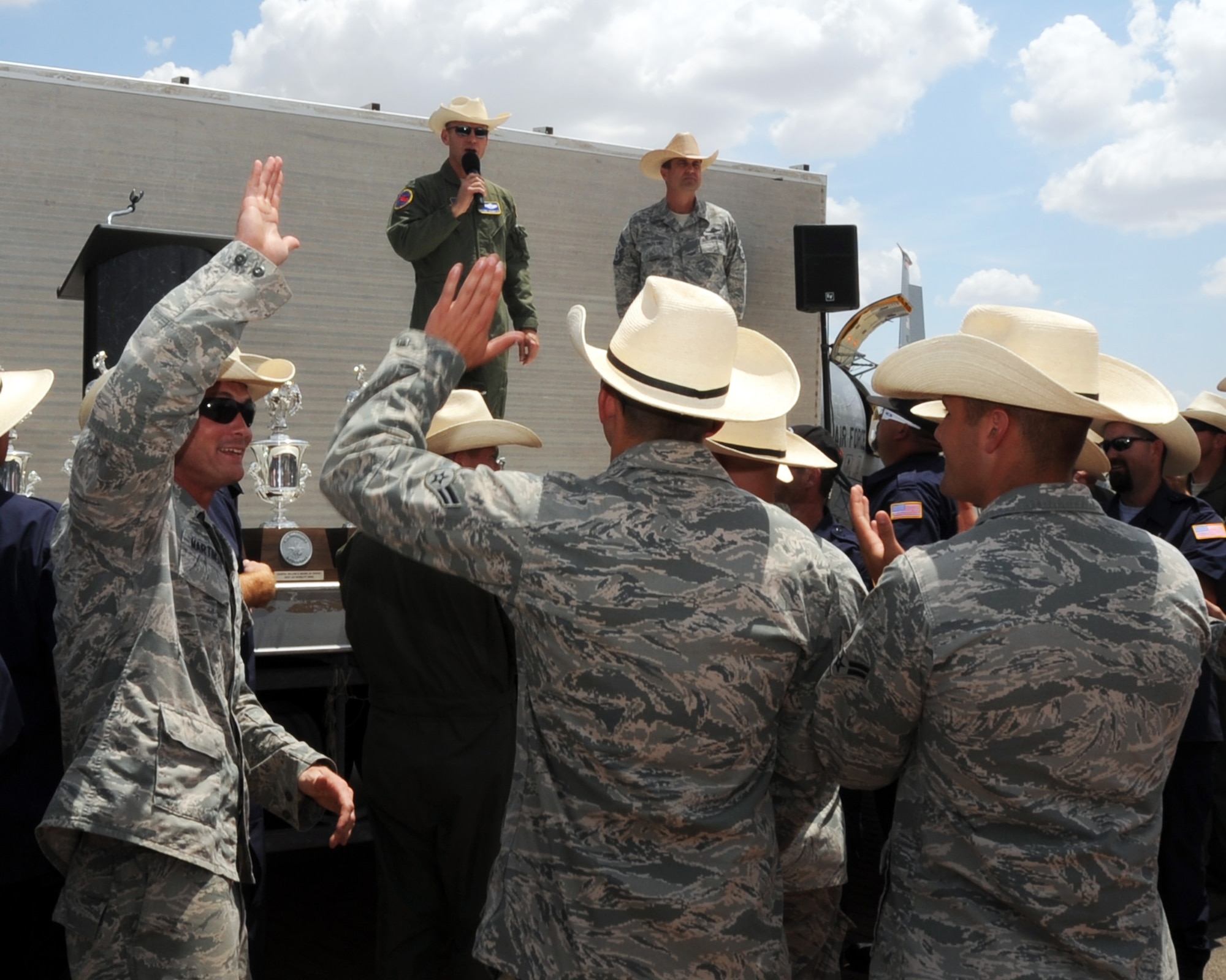 ALTUS AIR FORCE BASE, Okla. -- Col. Anthony B. Krawietz, 97th Air Mobility Wing commander, speaks to members of Altus' 2011 Air Mobility Command Rodeo Team and other spectators on the flight line here after returning from the 2011 AMC Rodeo at Joint Base Lewis-McChord Wash., July 30, 2011. Team Altus returned from the 2011 AMC Rodeo with 10 awards, including the top honor of "Best Air Mobility Wing". (U.S. Air Force photo by Airman 1st Class Kenneth W. Norman / Released / 97th Air Mobility Wing Public Affairs)