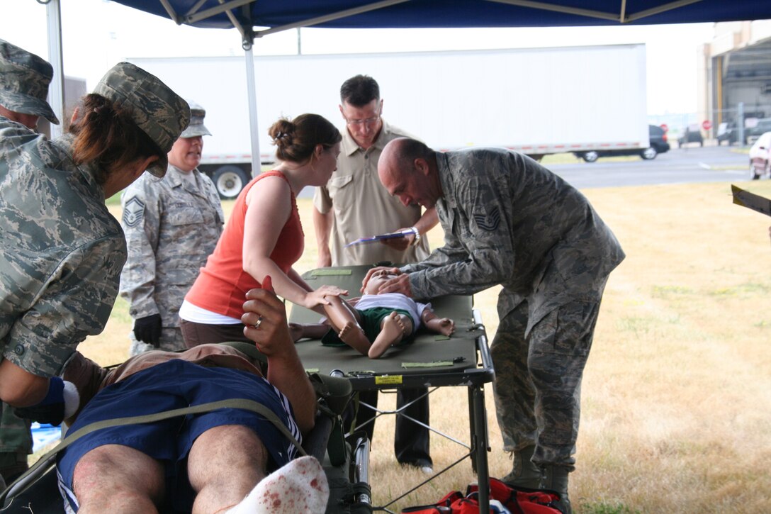 914th Aeromedical Staging Squadron Airmen participate in a mass casualty exercise during the July Unit Training Assembly at the Niagara Falls Air Reserve Station, N.Y.  July 25.To ensure readiness for the upcoming 2011 Thunder of Niagara Air Show, the exercise consisted of medical teams responding to multiple scenarios that could happen at any public event on base.  (U.S. Air Force courtesy photo by Tech Sgt. Jaimelynn Winkler)