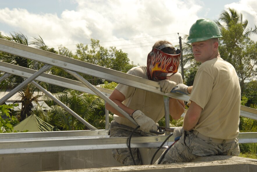 PARAMARIBO, SURINAME – Senior Airman Cody Hall, 114th Fighter Wing, Fire Protection (Right) holds a truss while Tech Sgt. Chris Steffen, 114th Fighter Wing Civil Engineer Squadron (left) welds the rafter into place. Hall’s civilian experience in construction has benefited him while helping the 114th Fighter Wing Civil Engineers. Twenty-two members of the 114th Fighter Wing are constructing a clinic in the Commewijne district of Suriname in support of exercise New Horizons. New Horizons is a cooperative effort between the government of Suriname and the United States Southern Command. (Air Force Photo by Master Sgt. Chris Stewart)(Released)