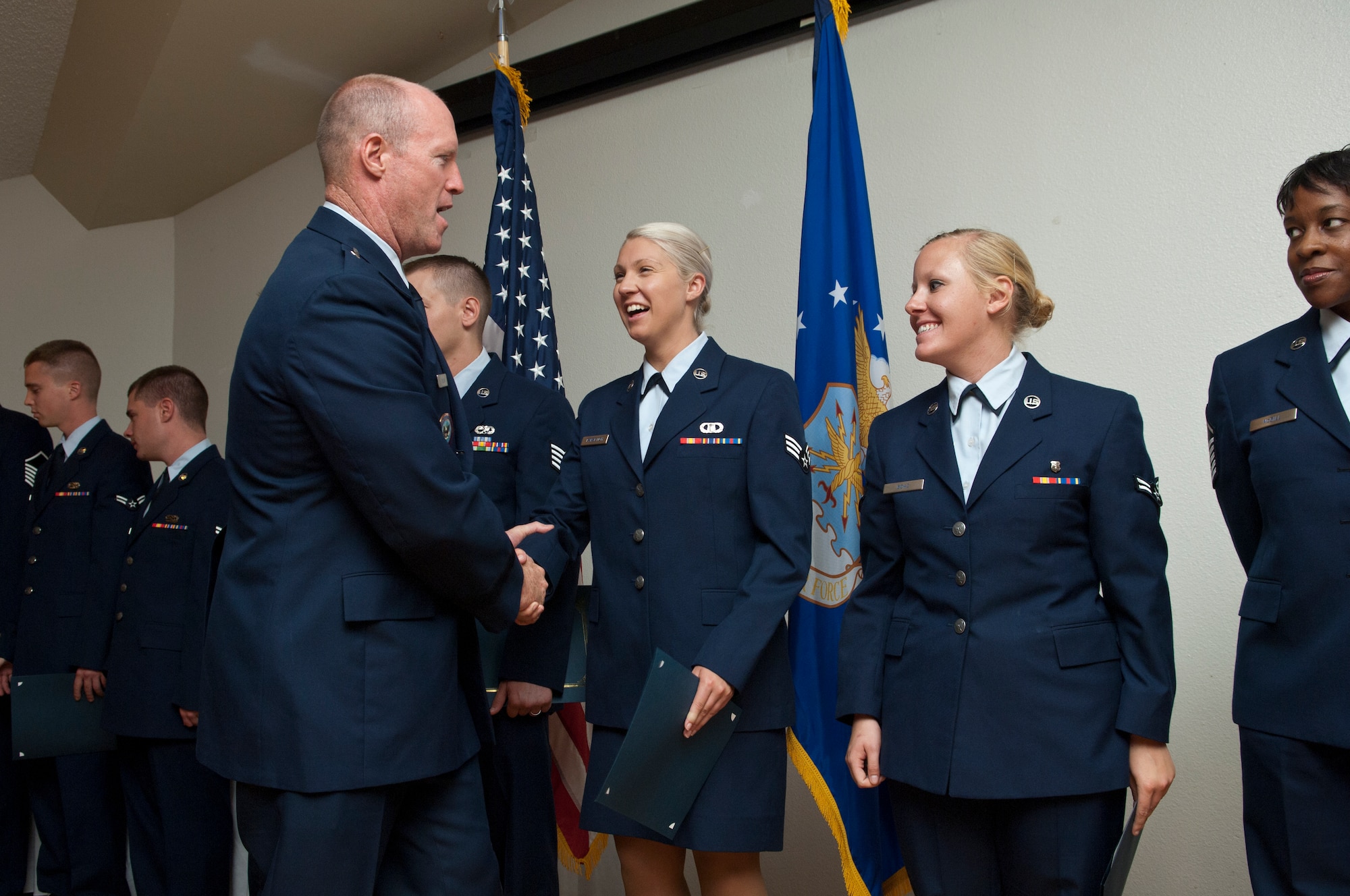 Brig. Gen. Robert C. Nolan II walks down the line to congratulate dozens of the 41 Edwards Airmen who were promoted during July. The July promotion ceremony was held July 29 in Club Muroc. (Air Force photo by Michael Yncera)