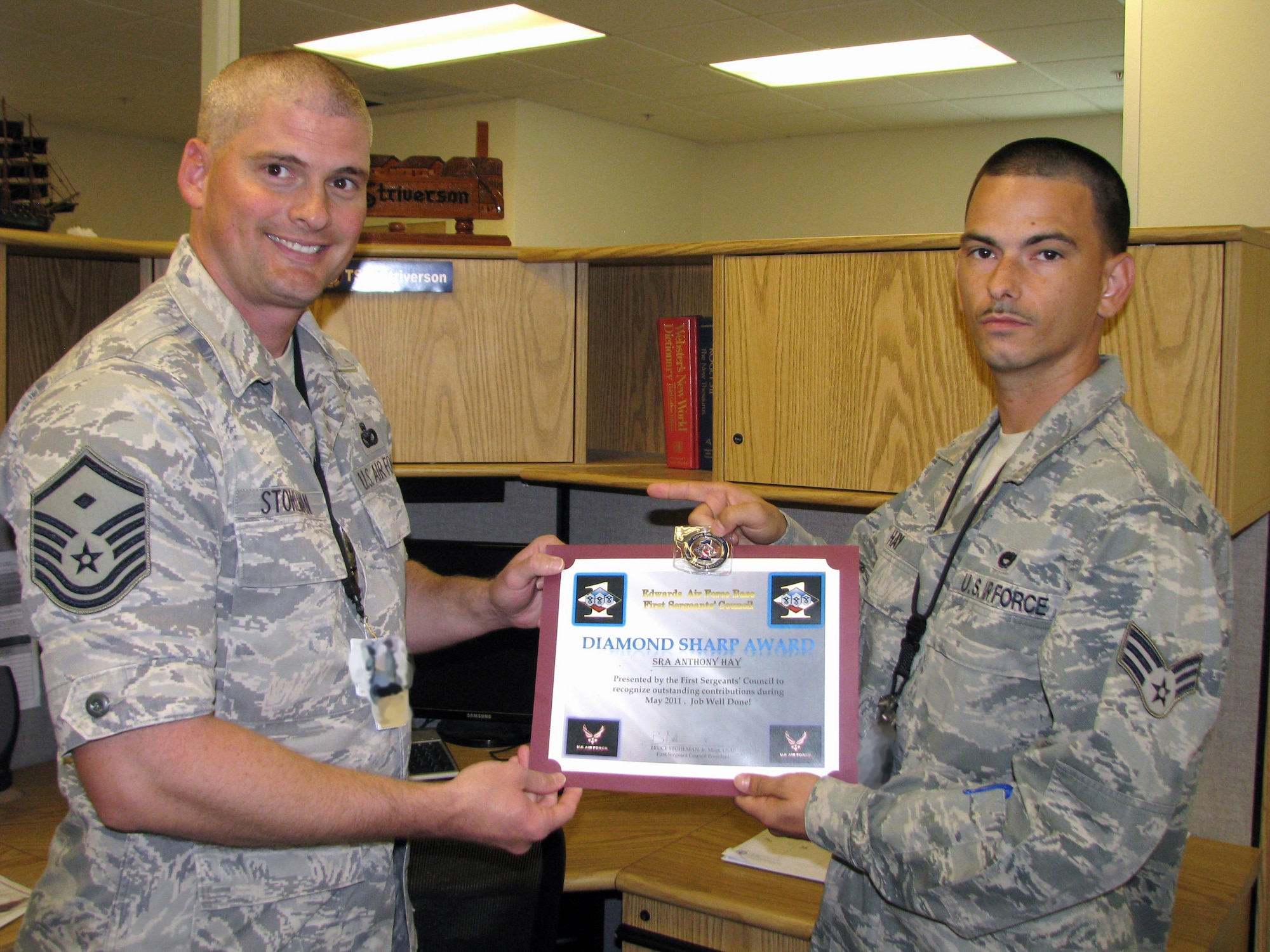 Master Sgt. Bruce Stohlman, 31st Test and Evaluation Squadron first sergeant, presents Senior Airman Anthony Hay, 31st TES, with the Diamond Sharp Award on behalf of the First Sergeant's Council. Stohlman also presented Hay with a First Sergeant's Council coin for a 'job well done.'"