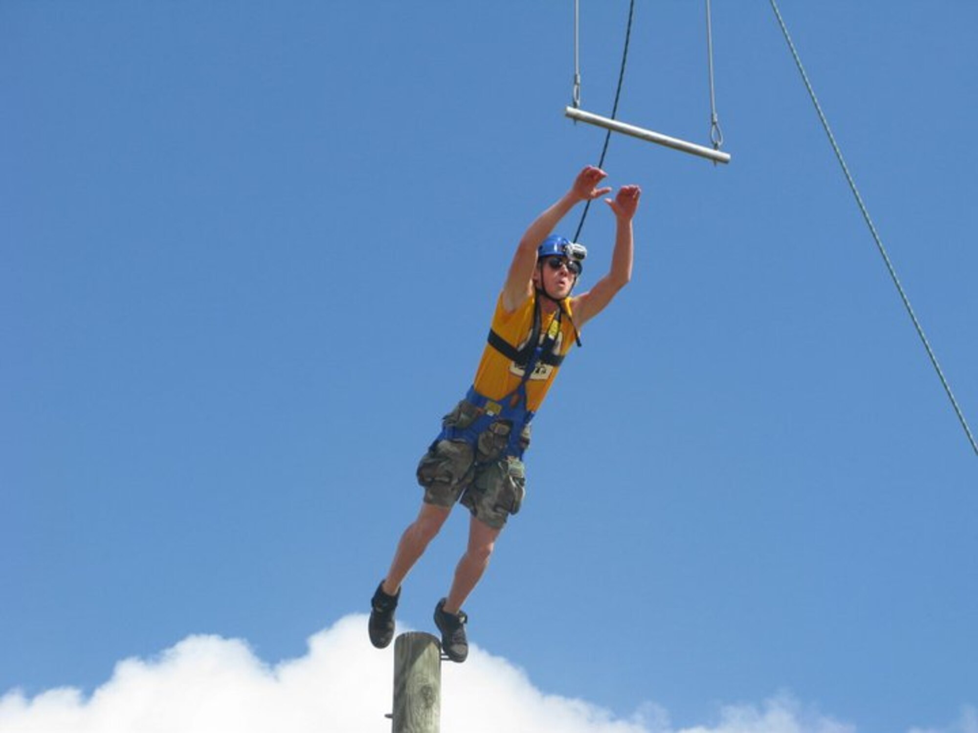 Cody Page, an Air Force teen from MacDill Air Force Base, Nev., jumps for a swinging bar during a high ropes challenge at Lackland Air Force Base, Texas July 12. The challenge was part of an Air Force Teen Leadership Camp held in San Antonio July 11-15. More than 80 Air Force teens from Air Force installations worldwide learned about college life, teamwork and leadership skills during the camp. (Courtesy photo) 

