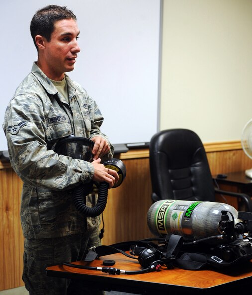 U.S. Air Force Airman 1st Class Danny Thompson, 20th Civil Engineer firefighter, shows the class the new mask portion of the new M-7 Firehawk self-contained breathing apparatus at the fire station Shaw Air Force Base, S.C. Aug. 2, 2011. The new M-7 Firehawk helps Airmen complete the mission by being more durable, safer, user friendly and uses one tank instead of two. The mask has more features which include a voice enhancer and a heads up display that shows how much air is left in the tank. (U.S. Air Force photo/Airman 1st Class Tabatha L. Duarte)(Released)