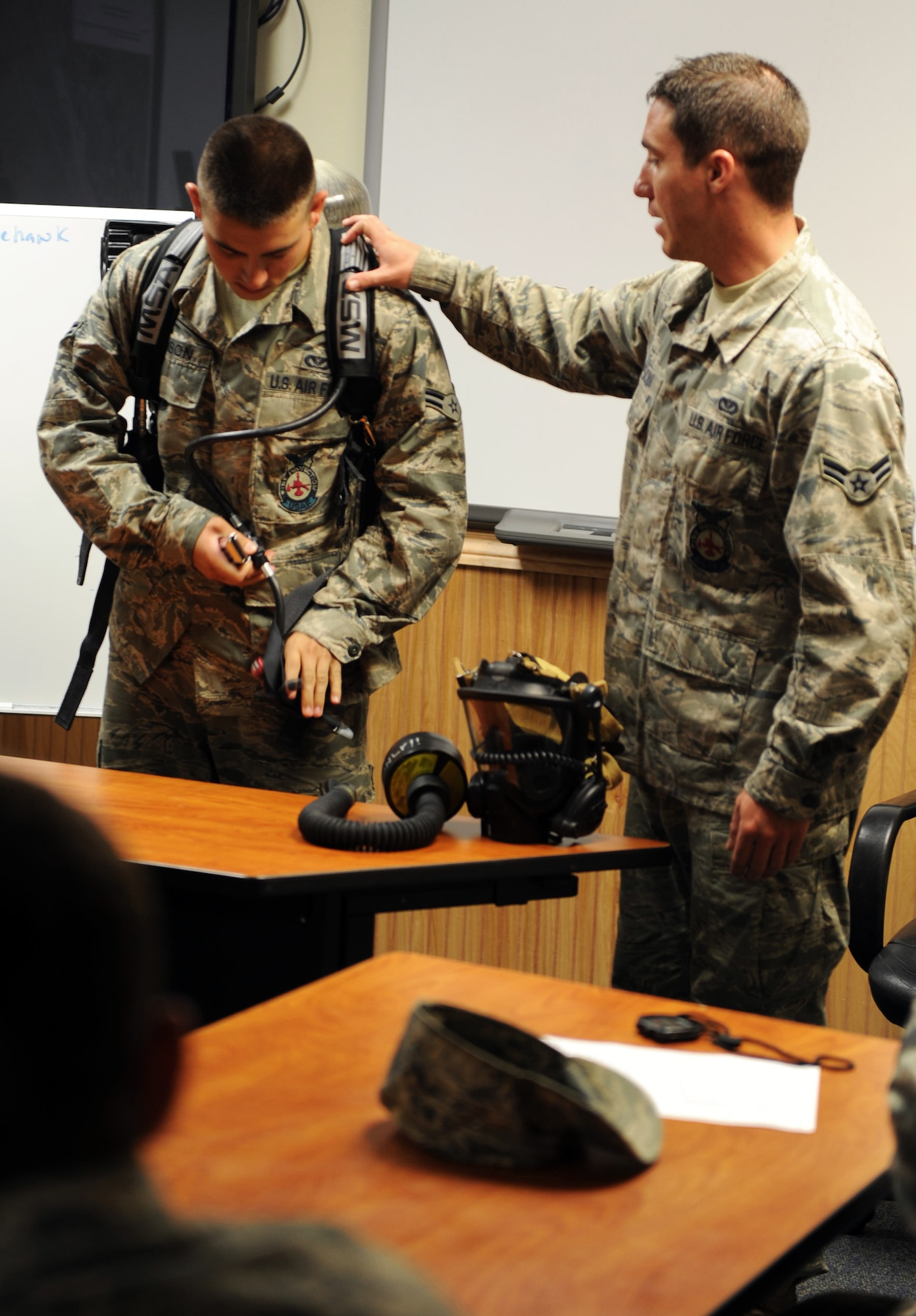 U.S. Air Force Airman 1st Class Danny Thompson, 20th Civil Engineer firefighter, teaches a class on the new M-7 Firehawk self-contained breathing apparatus at the fire station Shaw Air Force Base, S.C. Aug. 2, 2011. The new M-7 Firehawk helps Airmen complete the mission by being more durable, safer, user friendly and uses one tank instead of two. The mask has more features which include a voice enhancer and a heads up display that shows how much air is left in the tank. (U.S. Air Force photo/Airman 1st Class Tabatha L. Duarte)(Released)