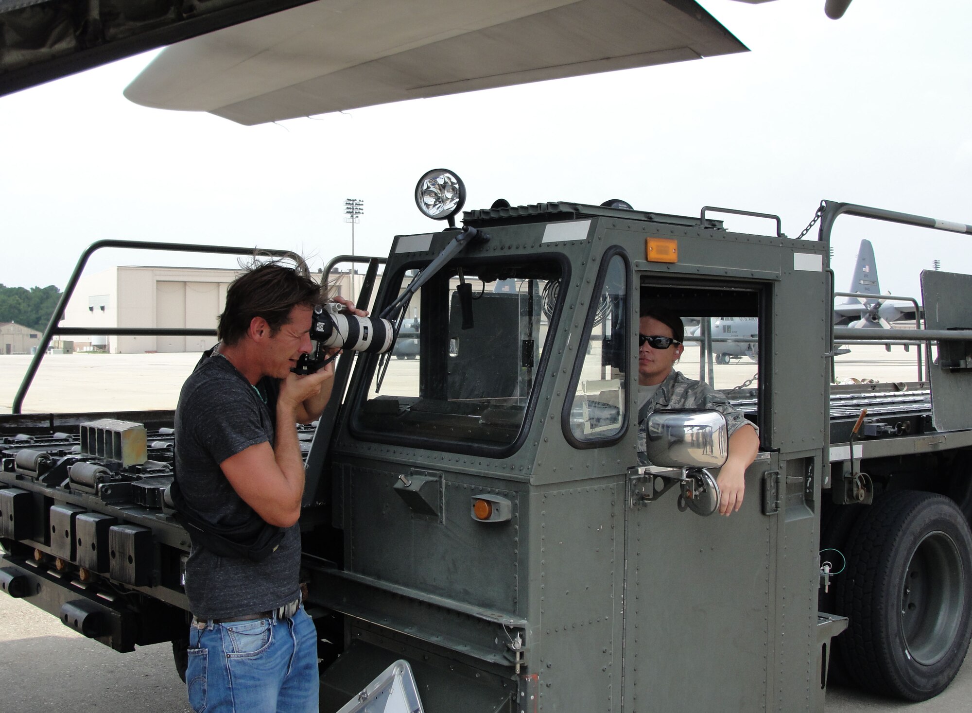 During the filming of the Extreme Makeover production on Pope Field's flightline, July 19, 2011,  show host Ty Pennington turns the camera Senior Airman Michelle Seal, 3rd Aerial Port Squadron k-loader operator. (U. S. Air Force photo by Major DeAnna Franks)                