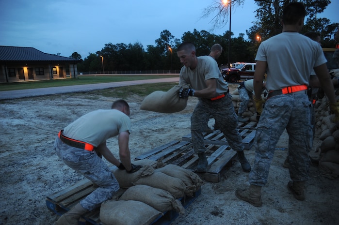 Staff Sgt. Ryan Barrows places a sandbag on a pallet at Gulfport Training Center, Miss. July 28. Barrows is a heating, ventilation and air conditioning technician with the 628th Civil Engineer Squadron. (U.S. Air Force photo/Staff Sgt. Katie Gieratz
