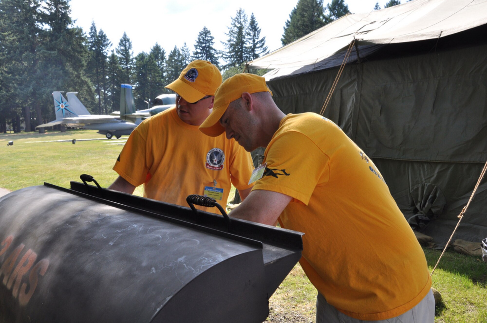 Master Sgt. Chad Eccles, 2nd Air Refueling Squadron, and Staff Sgt. Justin Taydus, 305th Operations Support Squadron, prepare fresh cheesesteaks after the day’s events at Air Mobility Rodeo 2011.  It is Rodeo tradition for each team to bring and share products typical of the region they come from. (U.S. Air Force photo by 1st Lt. Carolyn Glover/Released)  