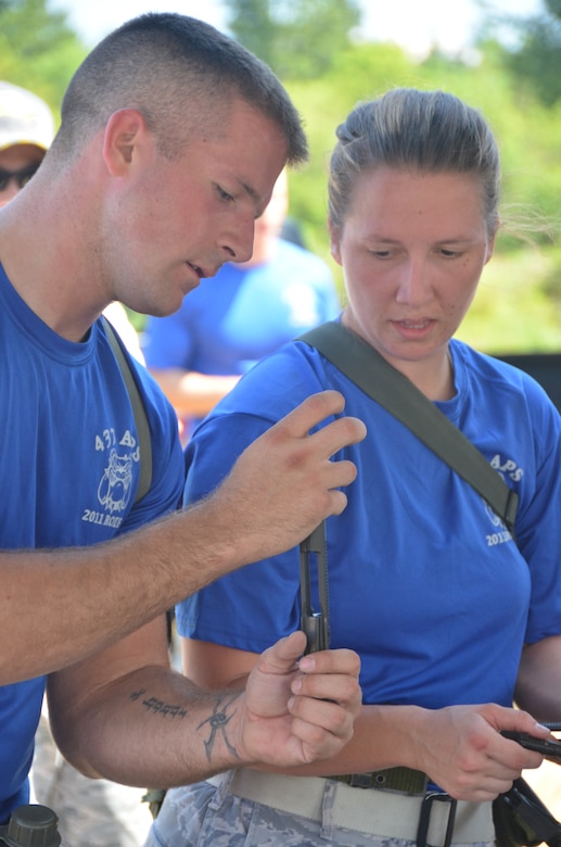 Staff Sgt. Nicholas Sansone (left) helps his wingman Staff Sgt. Ashley Kelly put together an M-16, July 28, 2011, at Joint Base Lewis-McChord, Wash., during an aerial port obstacle course. The course was part of Air Mobility Rodeo 2011, a biennial international competition that focuses on mission readiness, featuring airdrops, aerial refueling and other events that showcase the skills of mobility crews from around the world. Sansone and Kelly are air transportation specialist from the 437th Aerial Port Squadron. (U.S. Air Force photo /2nd Lt. Susan Carlson) 
