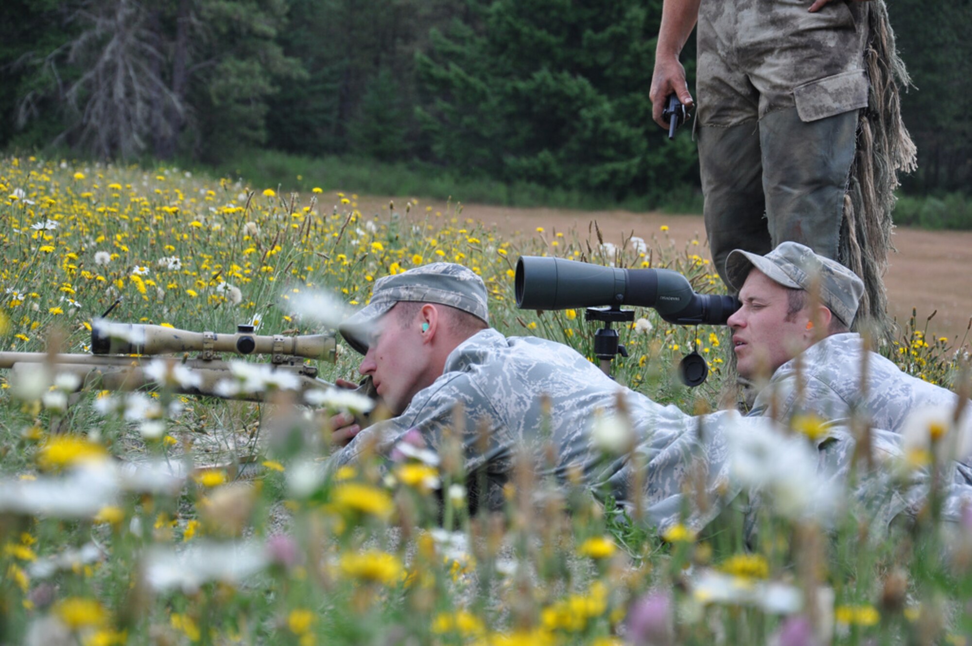 Tech Sgt. Trevor Casebolt and Senior Airman Dana Corriveau compete in the Rodeo 2011 Sniper competition at Joint Base Lewis-McChord, Wash. The competition consisted of precision shooting at targets up to 900 meters away. (U.S. Air Force photo by 1st Lt. Carolyn Glover/Released) 