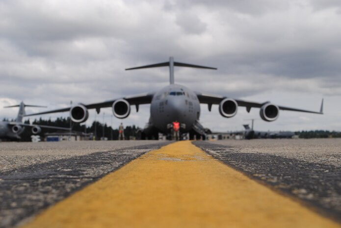 Team Charleston Rodeo participants from the 437th Aircraft Maintenance Squadron  guide the Charleston C-17 Globemaster III, July 27, 2011, at Joint Base Lewis-McChord, Wash., during Air Mobility Rodeo 2011. (U.S. Air Force photo/Capt. Kari Fleming) 