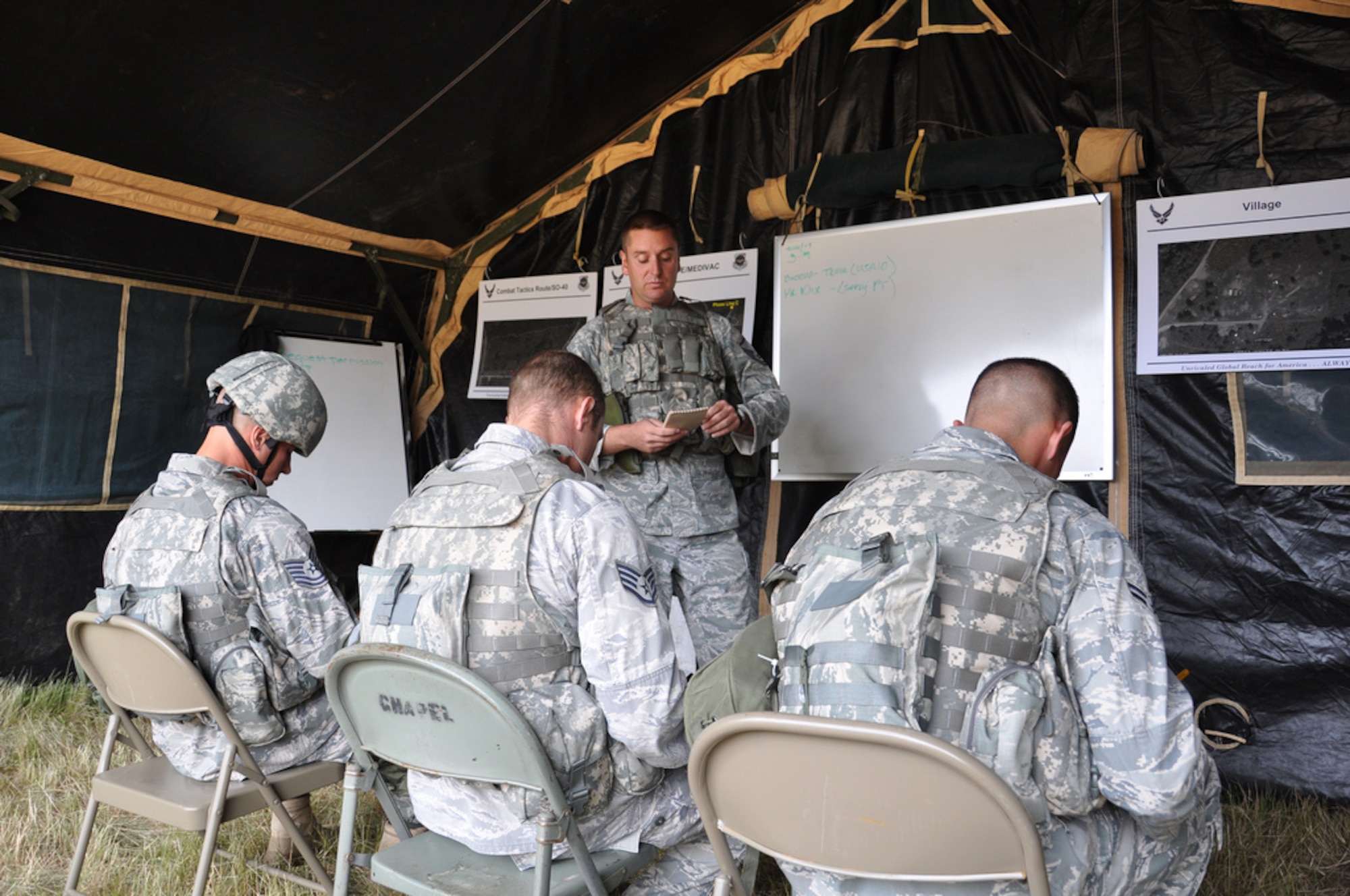 Master Sgt. Chris Wright, Security Forces team chief, briefs the SF team on an upcoming scenario during a combat tactics competition. Wright, along with Tech. Sgt. James Chubb, Tech Sgt. Trevor Casebolt and Airman 1st Class Morgan Buckley  won the competition. (U.S. Air Force photo by 1st Lt. Carolyn Glover/Released)  