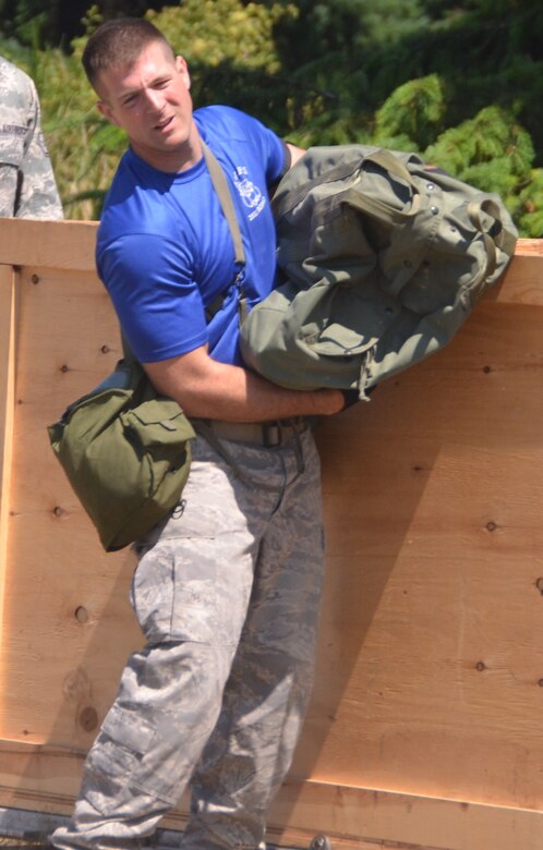 Staff Sgt. Nicholas Sansone carries a sandbag during an aerial port obstacle course, July 28, 2011, at Joint Base Lewis-McChord, Wash. The course was part of Air Mobility Rodeo 2011, a biennial international competition that focuses on mission readiness, featuring airdrops, aerial refueling and other events that showcase the skills of mobility crews from around the world. Sansone is an air transportation specialist from the 437th Aerial Port Squadron. (U.S. Air Force photo /2nd Lt. Susan Carlson) 