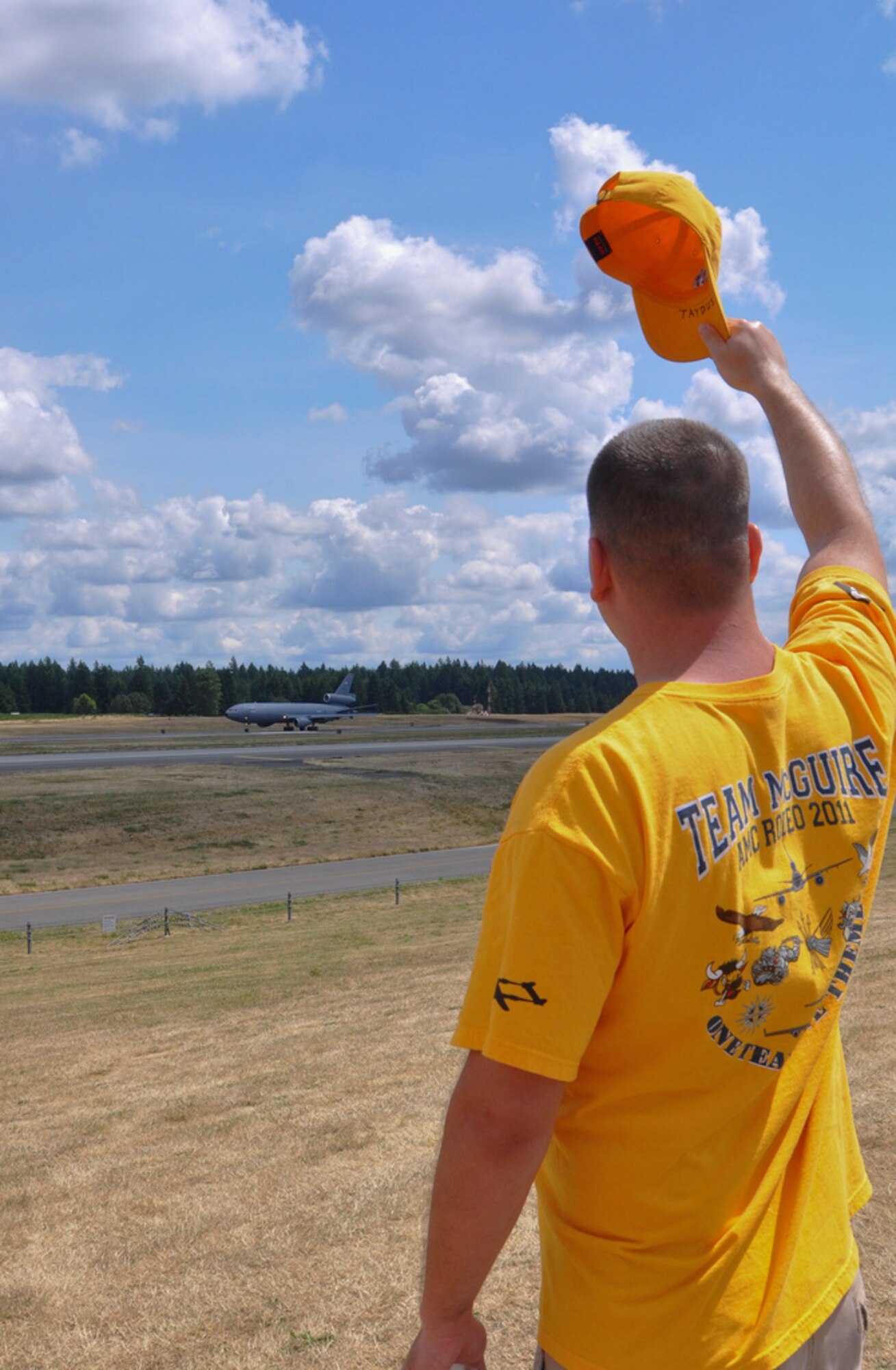Staff Sgt. Justin Taydus, 305th Operations Support Squadron, wishes luck to the KC-10 Extender aircrew at the start of a refueling mission competition during Rodeo 2011. (U.S. Air Force photo by 1st Lt. Carolyn Glover/Released)