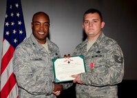 Col. Trent Edwards, 28th Mission Support Group commander, presents Tech. Sgt. Kevin Jones, 28th Civil Engineer Squadron vehicle and equipment maintenance mechanic, with the Bronze Star Medal at Ellsworth Air Force Base, S.D., July 21, 2011. Tech. Sgt. Jones received the Bronze Star Medal for his meritorious service during Operation Enduring Freedom from Oct. 6, 2009 through April 6, 2010. (U.S. Air Force photo/Airman Alystria Maurer/Released)