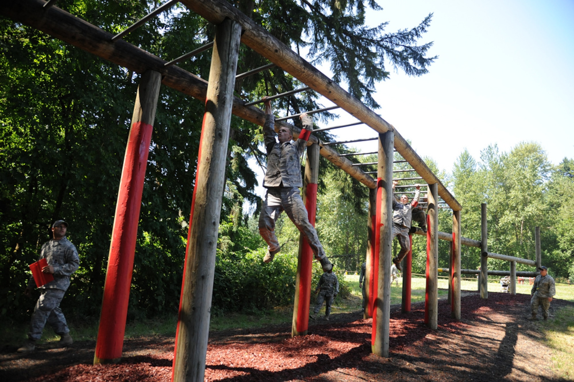 Senior Airman Tim Dent and Senior Airman Adam Bearor, 621st Contingency Response Wing security forces, swing through a portion of the combat endurance course at the Air Mobility Rodeo 2011, July 28, Joint Base Lewis-McChord, Wash. (U.S. Air Force photo by 1st Lt. Brooke Brzozowske/Released)
