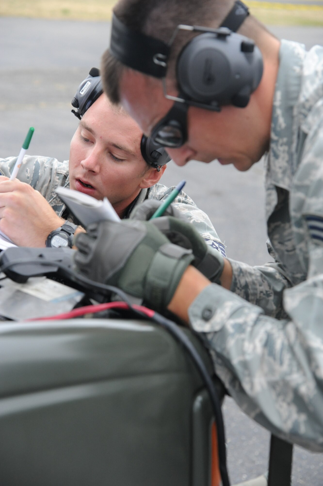 Staff Sgt. Thomas Zahner and Senior Airman Michal Szczepanik, 621st Contingency Response Wing, work through the engine running onload/offload competition July 25, at Air Mobility Rodeo 2011, Joint Base Lewis-McChord. (U.S. Air Force photo by 1st Lt. Brooke Brzozowske/Released)