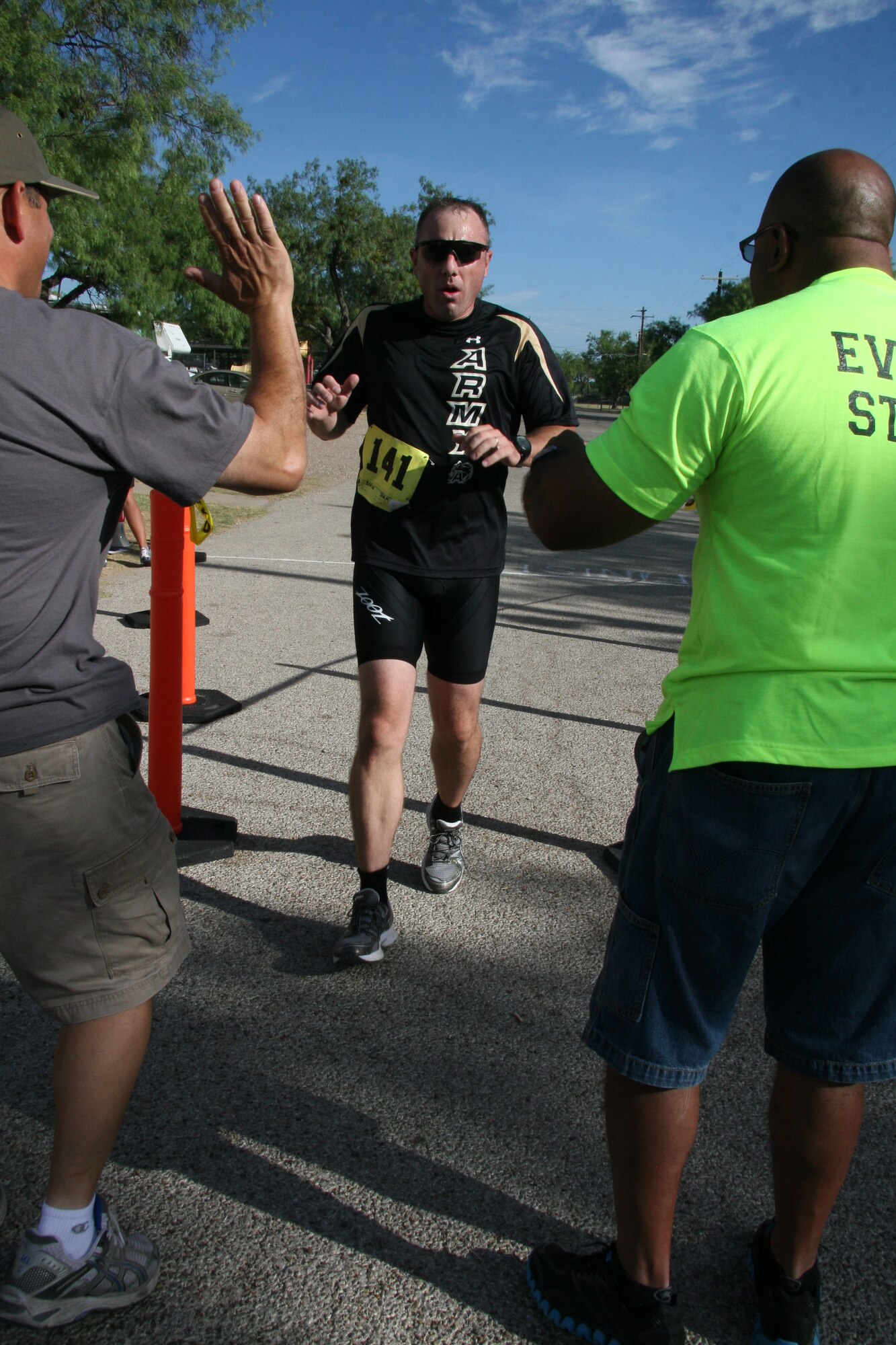 GOODFELLOW AIR FORCE BASE, Texas – Army Lt. Col. John Bonin, 344th Military Intelligence Battalion Commander, completes the last leg of the 5-kilometer run during the 2011 Triathlon July 30 at the Outdoor Recreation Camp. More than 150 people from Goodfellow and community participated in the event at the Rec Camp. (Courtesy photo/Julie Manuel)