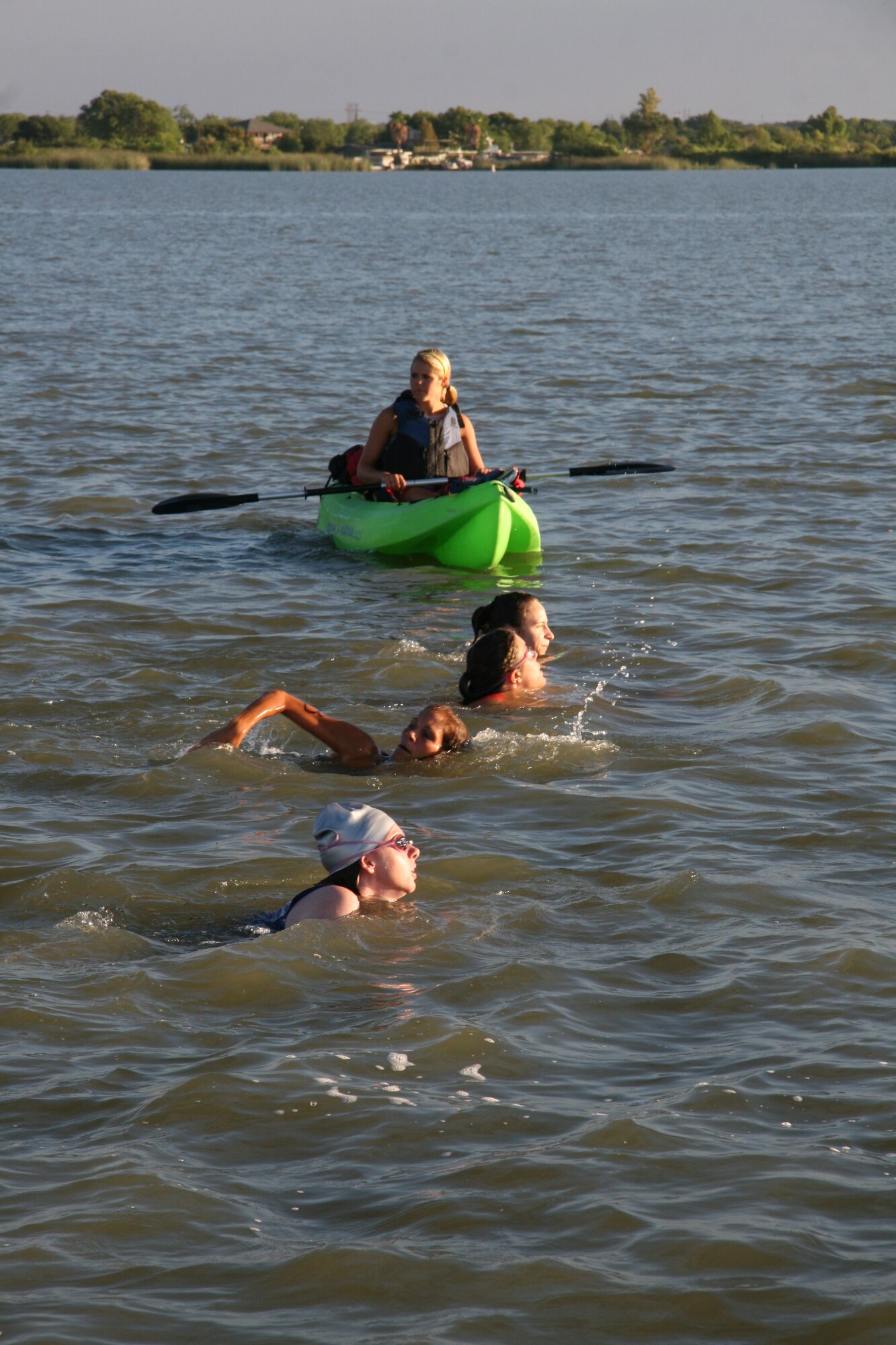 GOODFELLOW AIR FORCE BASE, Texas – Courtney Hoelscher, Outdoor Recreation Camp lifeguard watches on as participants tackle the 400-meter open water portion of 2011 Triathlon July 30. More than 150 people from Goodfellow and local community participated in the event, which also included a 20-kilometer bike ride and 5-kilometer run. (Courtesy photo/Julie Manuel)