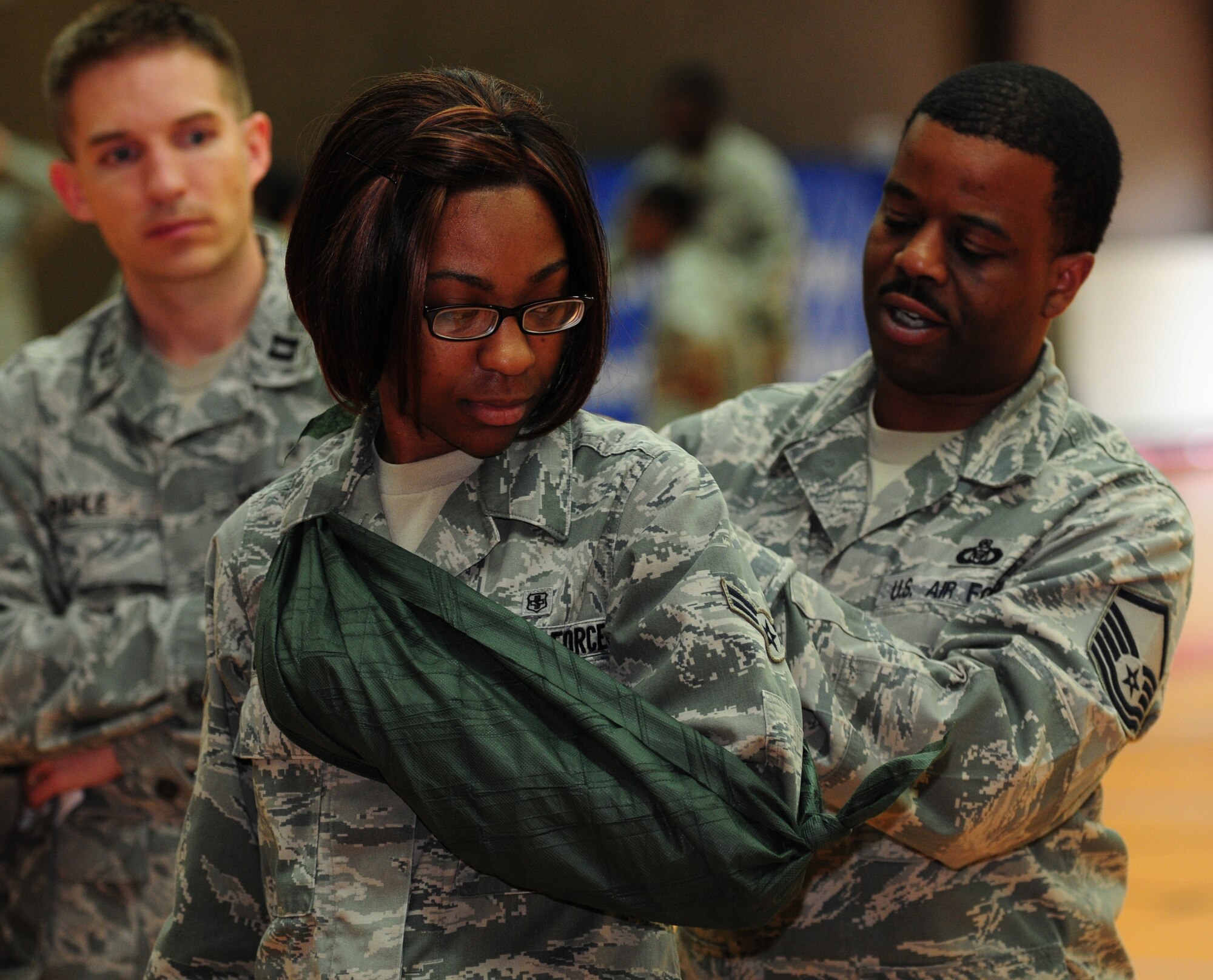 SPANGDAHLEM AIR BASE, Germany – Master Sgt. Khalifah Woodard, 606th Air Control Squadron superintendant of operations training, tightens a sling on Airman 1st Class Teri Cooper, 52nd Aerospace Medical Squadron medical standards technician journeyman, during self aid and buddy care hands-on training here July 28. The training took place to ensure Saber Airmen are prepared for potential deployments, local disasters, humanitarian missions and homeland attacks. (U.S. Air Force photo/Airman 1st Class Matthew B. Fredericks)