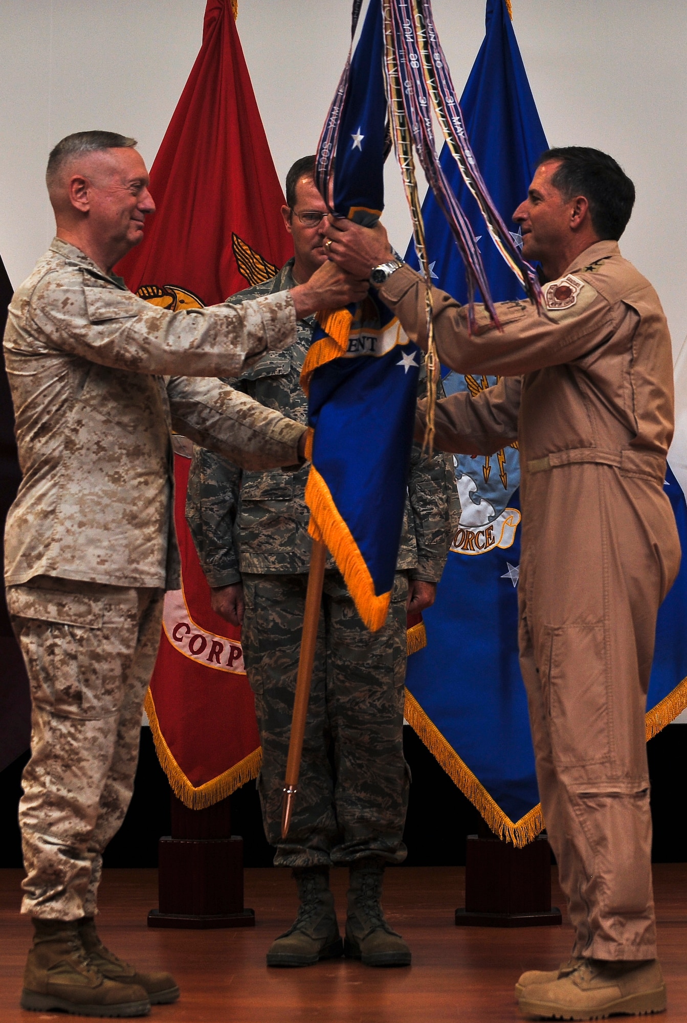 Marine Gen. James N. Mattis, commander of U.S. Central Command, passes the U.S. Air Forces Central Command guidon to Lt. Gen. David L. Goldfein at the USAFCENT change of command ceremony, Aug. 3, 2011, in Southwest Asia. (U.S. Air Force photo/Senior Airman Paul Labbe)
