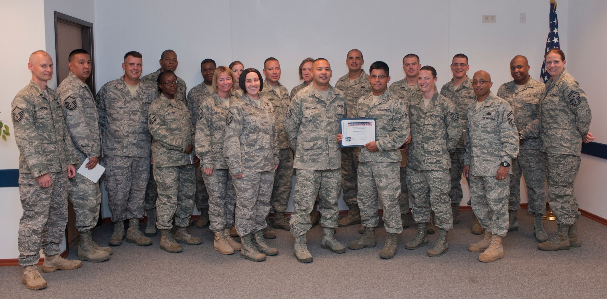 Senior Airman Andres Picado, 39th Communications Squadron, receives the Unsung Hero Award from members of the Incirlik Top 3 Aug. 3, 2011, at Incirlik Air Base, Turkey. The Top 3 presents this award monthly to Airmen who demonstrate superior job performance and exceptional leadership. (U.S. Air Force photo by Airman 1st Class Clayton Lenhardt/Released)