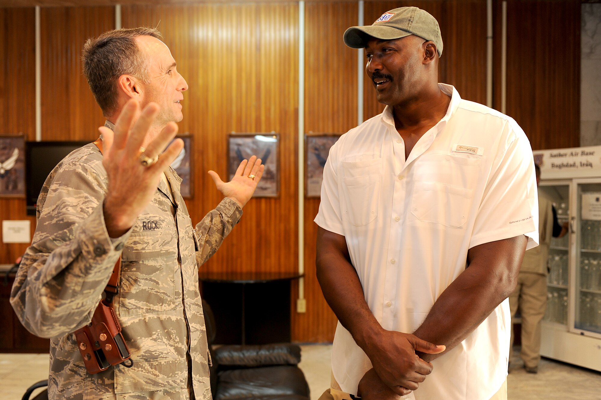 Brig. Gen. Anthony Rock, 321st Air Expeditionary Wing commander and Iraqi Training and Advisory Mission-Air director, talks basketball with Karl Malone during a visit to Sather Air Base, Iraq, Aug. 2, 2011. Malone, a former National Basketball Association professional basketball player, and David Blaine, an illusionists and magician, visited Airmen here as part of a three country, six-day USO tour. (U.S. Air Force photo/Staff Sgt. Mike Meares)