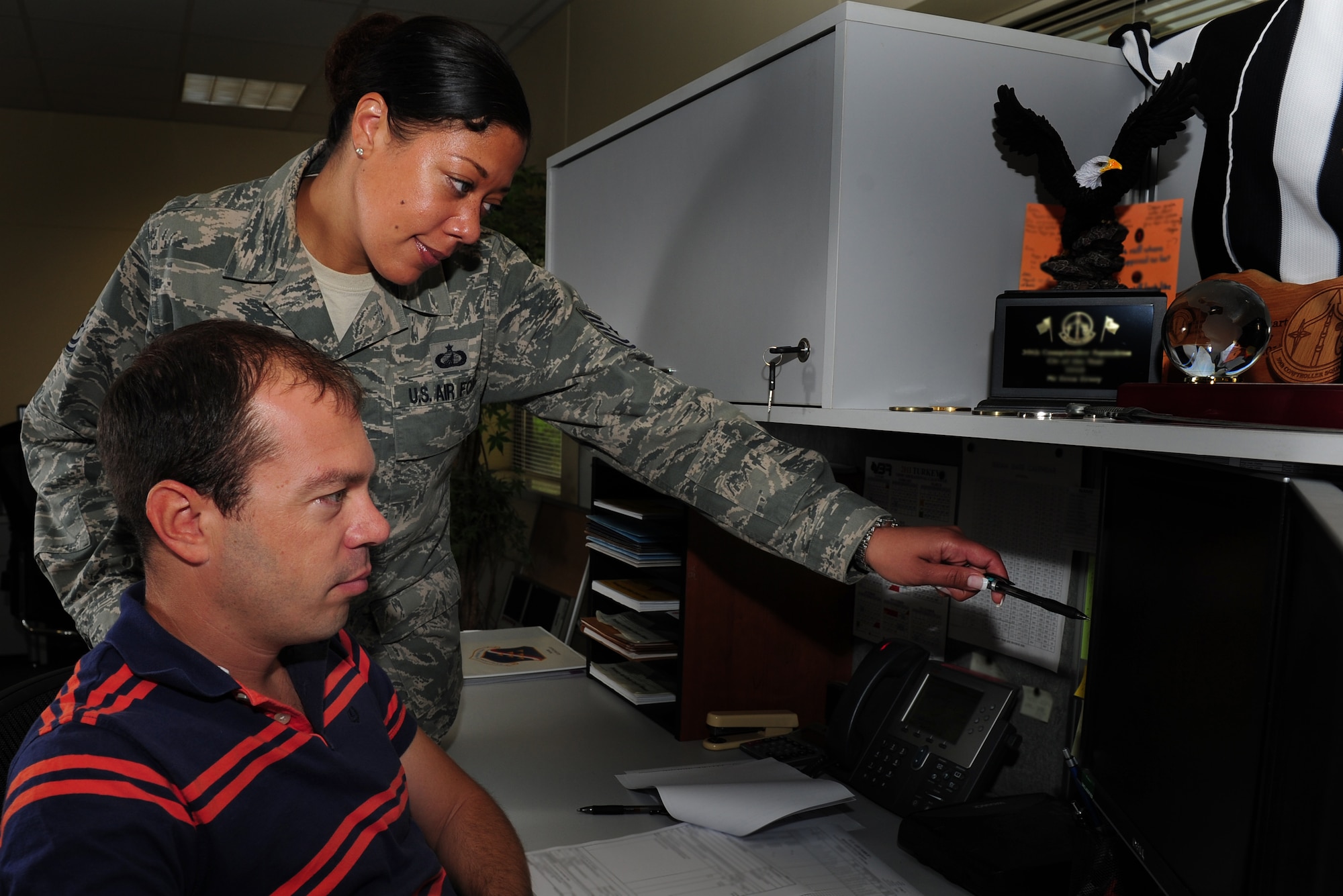 Tech. Sgt. Melanie Townsend, 39th Comptroller Squadron budget analysis NCO in charge, assists a co-worker Aug. 8, 2011, at Incirlik Air Base, Turkey. Townsend graduated from Kisling NCO Acadamy at Ramstein Air Base, Germany July 14, 2011, and received the Commandant's Award, which is presented to the student who, in the commandant’s judgment, made the most significant contribution to the overall success of the class. (U.S. Air Force photo by Senior Airman Anthony Sanchelli/Released)
