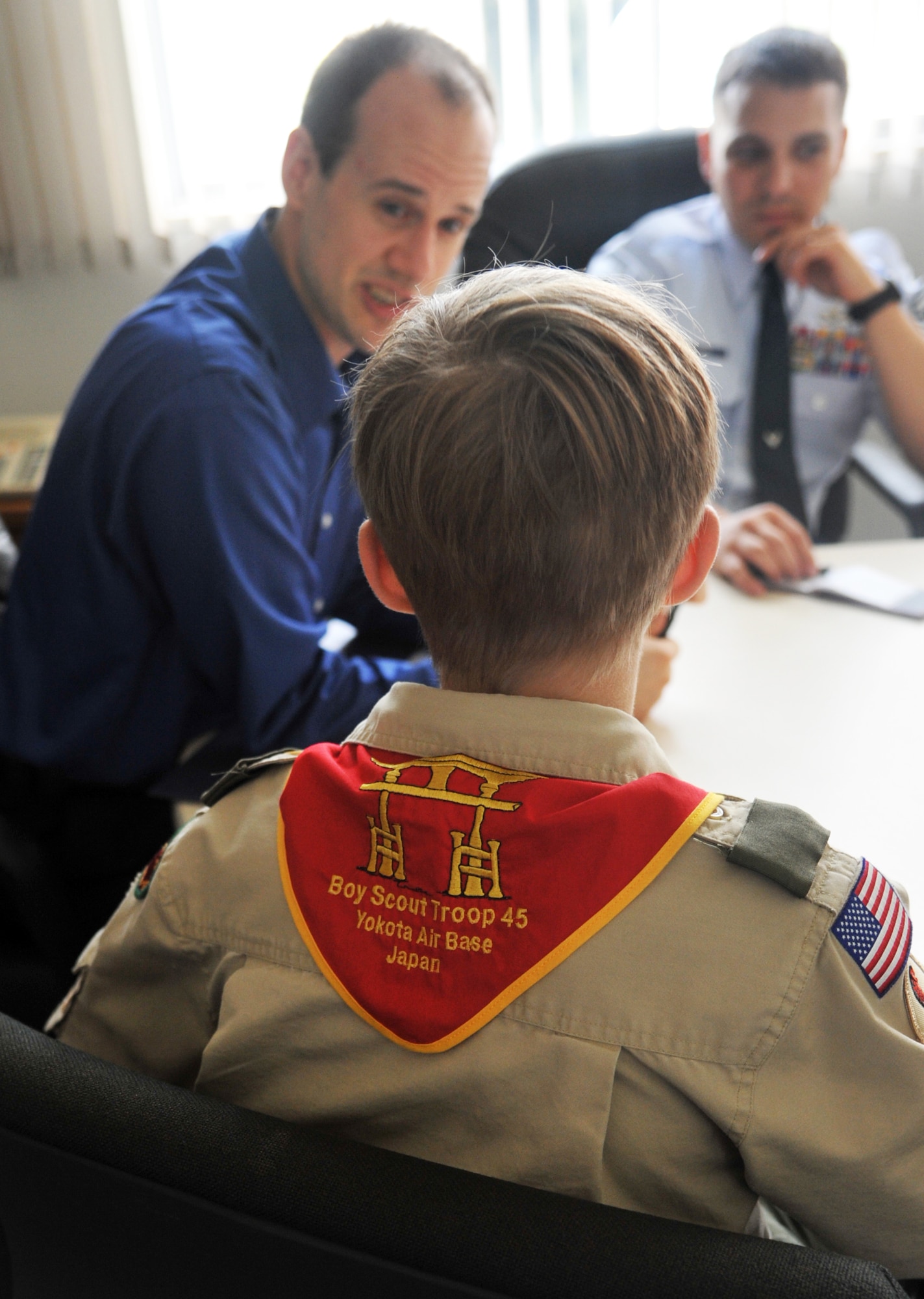YOKOTA AIR BASE, Japan -- Zach Lindsey, a Boy Scout from Troop 45, asks Christopher Cook, Yokota Air Base energy manager, and Senior Master Sgt. William Arcuri, 374th Civil Engineer Squadron facilities superintendent, questions about energy conservation. Aaron and Zach were researching to find ways for people to help conserve energy.  (U.S. Air Force photo/Airman 1st Class Krystal M. Garrett)