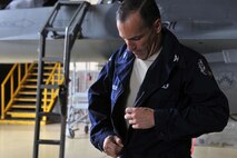 KUNSAN AIR BASE, Republic of Korea -- Col. Scott Pleus, 8th Fighter Wing commander, puts on a set of overalls here August 2. Col. Pleus visited each section of the Maintenance Group as part as his Immersion tour of the base. (U.S. Air Force photo/Senior Airman Brittany Y. Bateman)