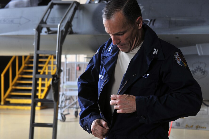 KUNSAN AIR BASE, Republic of Korea -- Col. Scott Pleus, 8th Fighter Wing commander, puts on a set of overalls here August 2. Col. Pleus visited each section of the Maintenance Group as part as his Immersion tour of the base. (U.S. Air Force photo/Senior Airman Brittany Y. Bateman)