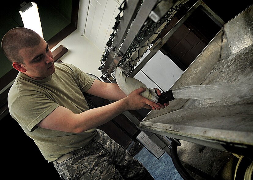 An Air Crew Flight Equipment Journeyman, Senior Airman Anthony Sportsman from the 51st Operation Support Squadron inspected an anti-exposure suit using the water tester.  Airman Sportsman sealed the feet, arms and neck openings of the anti exposure suit.  Once sealed, he filled the suit with water.  After the suit was completely filled with water, he looked for beads of water to form [an indication of a small hole or tear].  In the event that a small hole or tear is found Airman Sportsman circles the area with a black grease pencil.  When all the holes are found and circled, Airman Sportsman then empties the suit, turns it inside-out and sets it to dry for the necessary repairs to be made.  The anti-exposure suit is a vital operational item and mandatory for pilots that fly over waters that have a temperature of 50 degrees or below.(U.S. Air Force Photo by/Staff Sgt. Daylena Gonzalez)