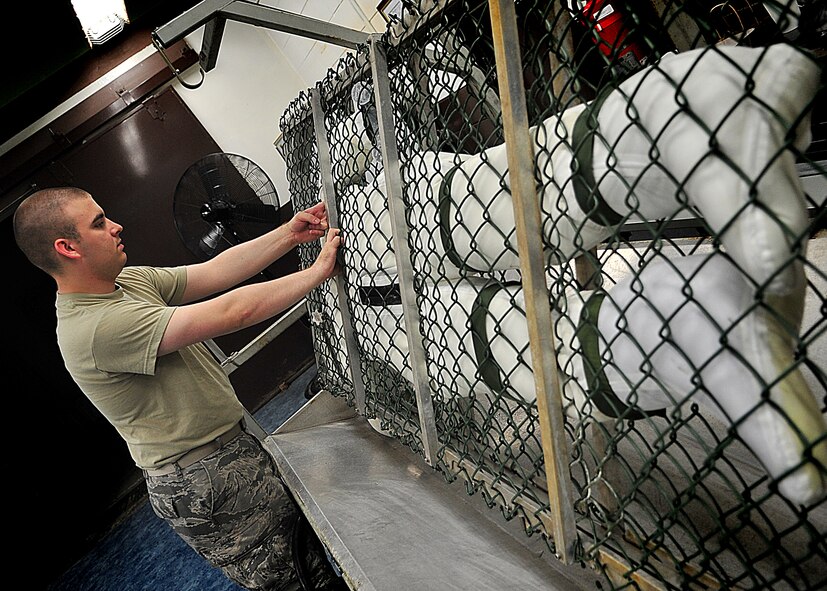 An Air Crew Flight Equipment Journeyman, Senior Airman Anthony Sportsman from the 51st Operation Support Squadron inspected an anti-exposure suit using the water tester.  Airman Sportsman sealed the feet, arms and neck openings of the anti exposure suit.  Once sealed, he filled the suit with water.  After the suit was completely filled with water, he looked for beads of water to form [an indication of a small hole or tear].  In the event that a small hole or tear is found Airman Sportsman circles the area with a black grease pencil.  When all the holes are found and circled, Airman Sportsman then empties the suit, turns it inside-out and sets it to dry for the necessary repairs to be made.  The anti-exposure suit is a vital operational item and mandatory for pilots that fly over waters that have a temperature of 50 degrees or below.(U.S. Air Force Photo by/Staff Sgt. Daylena Gonzalez)