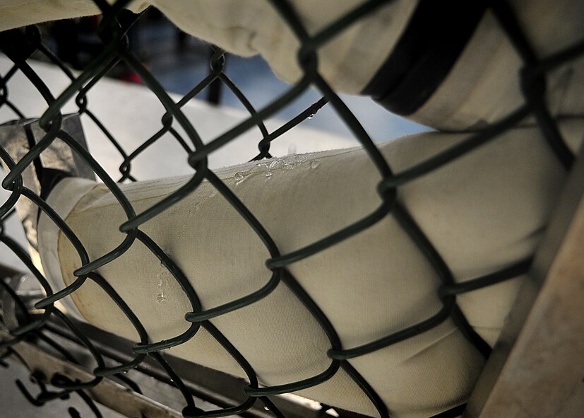 An Air Crew Flight Equipment Journeyman, Senior Airman Anthony Sportsman from the 51st Operation Support Squadron inspected an anti-exposure suit using the water tester.  Airman Sportsman sealed the feet, arms and neck openings of the anti exposure suit.  Once sealed, he filled the suit with water.  After the suit was completely filled with water, he looked for beads of water to form [an indication of a small hole or tear].  In the event that a small hole or tear is found Airman Sportsman circles the area with a black grease pencil.  When all the holes are found and circled, Airman Sportsman then empties the suit, turns it inside-out and sets it to dry for the necessary repairs to be made.  The anti-exposure suit is a vital operational item and mandatory for pilots that fly over waters that have a temperature of 50 degrees or below.(U.S. Air Force Photo by/Staff Sgt. Daylena Gonzalez)