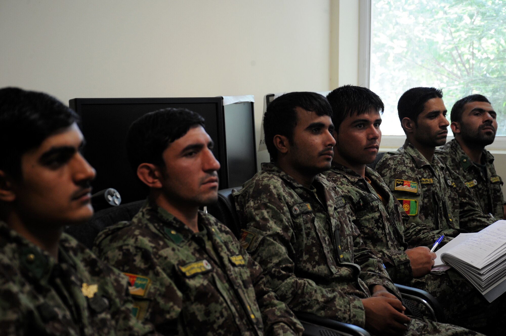 Afghan Air Force students listen to instruction at Pohantoon-e-Hawayee, the AAF’s “Air University,” listen to their instructor as he teaches them about fire safety August 2, 2011. PeH is located on the AAF compound in Kabul and currently has 593 students enrolled from all over Afghanistan in various classes and is the primary in-processing point for all training conducted in the AAF. (U.S. Air Force photo by Staff Sgt. Matthew Smith)