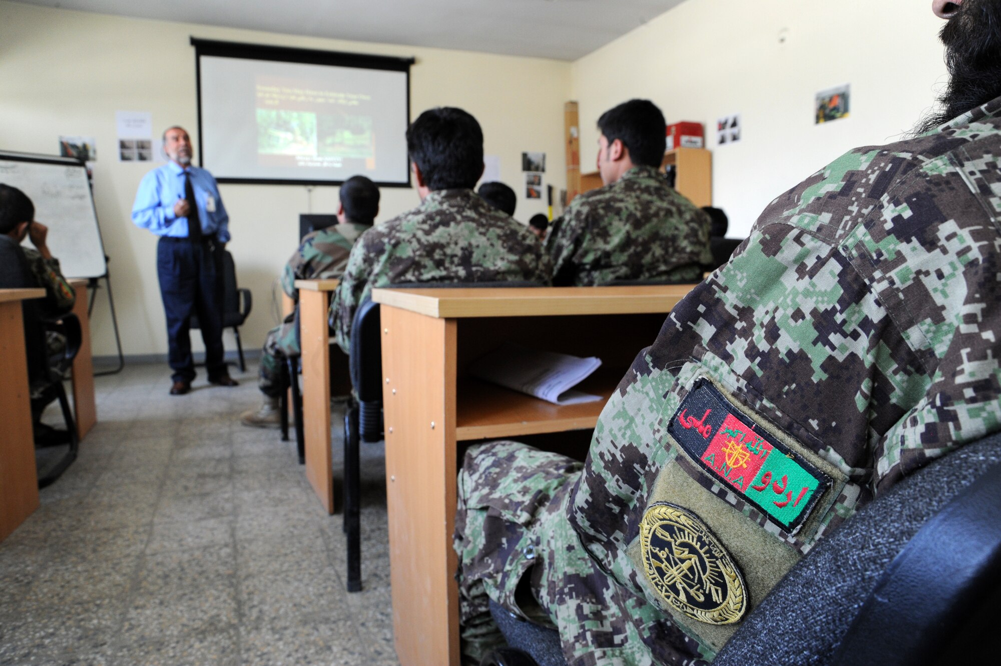 Afghan Air Force firefighting students at Pohantoon-e-Hawayee, the Afghan Air Force’s “Air University,” listen to their instructor as he teaches them about fire safety August 2, 2011. PeH is located on the AAF compound in Kabul and currently has 593 students enrolled from all over Afghanistan in various classes and is the primary in-processing point for all training conducted in the AAF. (U.S. Air Force photo by Staff Sgt. Matthew Smith)