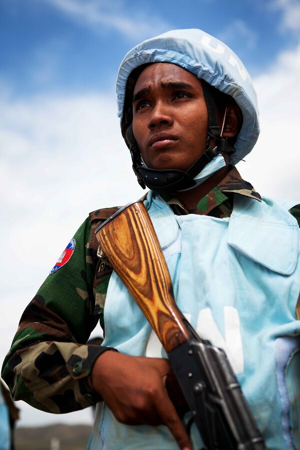 A soldier from the Cambodian National Peacekeeping Platoon, Cambodian Army, guards the entrance to a mock forward operating base at the distribution site security lane of the field training exercise at Exercise Khaan Quest 2011 at Five Hills Training Area near Ulaanbaatar, Mongolia, Aug. 1. The platoon trained to protect food, water and humanitarian supplies at a distribution site within the scenario. The multinational training was conducted with the combined expertise of all participating nations, including Indonesia, Mongolia, Republic of Korea and India. Khaan Quest is a training exercise designed to strengthen the capabilities of participating nations’ forces in international peace support operations worldwide.