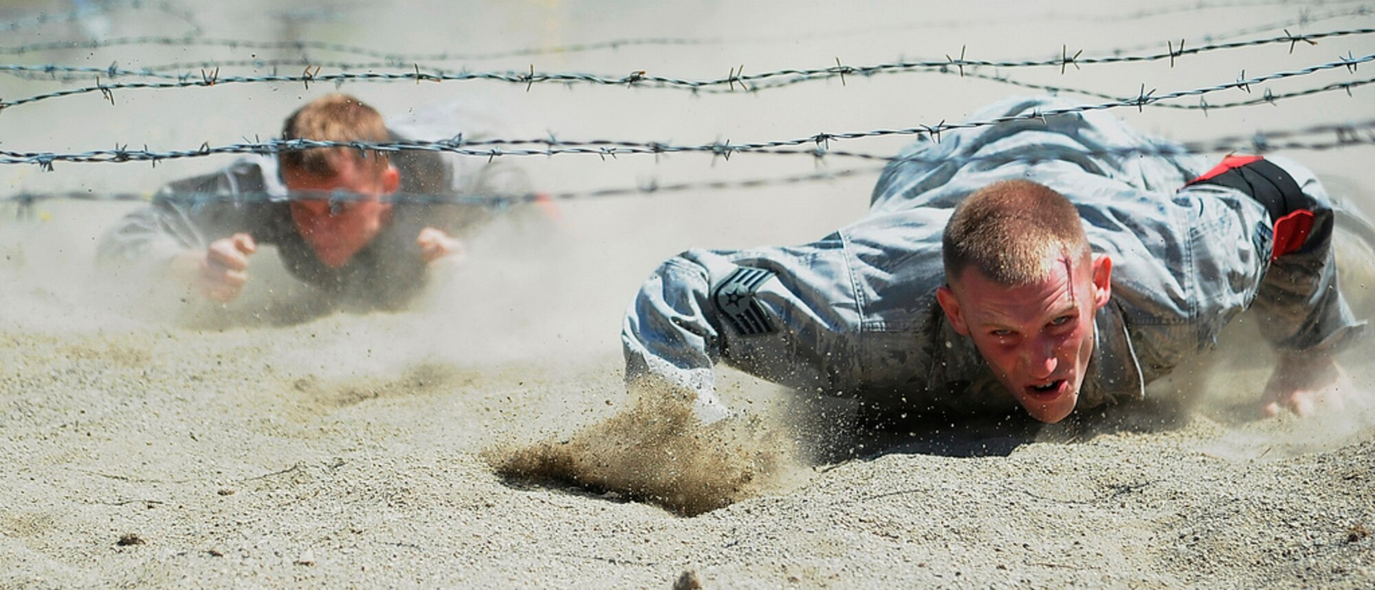 Staff Sgt. Stephen Barber and Senior Airman Tim Dent low crawl through the combat endurance event July 28, 2011, during Air Mobility Rodeo 2011 at Joint Base Lewis-McChord, Wash. Barber and Dent are assigned to the 621st Contingency Response Wing. (U.S. Air Force photo/1st Lt. Brooke Brzozowske)
