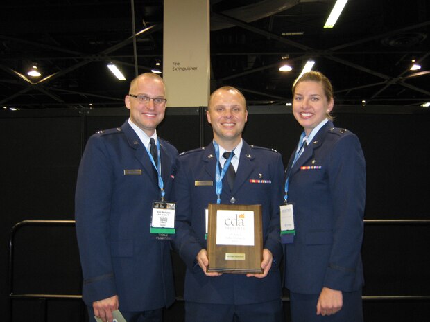 Captains Kevin Rasmussen, Joe Kayne and Danielle Wehri, 99th Dental Squadron advanced education of general dentistry residents, accept their awards during the awards ceremony for the California Dental Association table clinic competition held May 14, 2011, in Anaheim, Calif.  Rasmussen won first place for his table clinic entitled “Surgical Removal of Mandibular Tori Utilizing Mucoperiosteal Ballooning.”  Kayne won second place for his table clinic entitled “Connective Tissue Grafting Techniques to Treat Millers I/II Defects.”  Wehri won third place for her table clinic entitled “Acute Orofacial Pain: Simple steps the general dentist can take at the first visit.”  The three captains competed against 45 other table clinic presenters who were from the Air Force, Navy and Veteran’s Affairs. (Courtesy photo)
